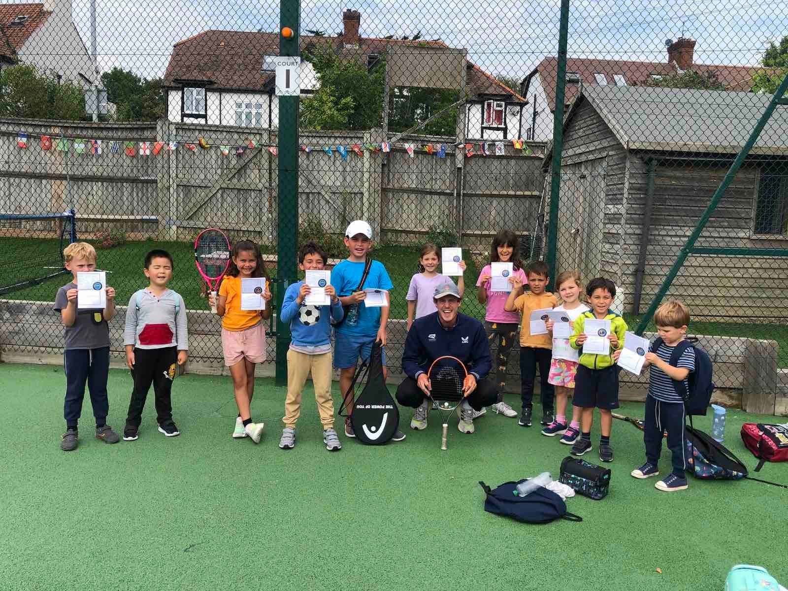 Junior players and a Metro Tennis coach on court
